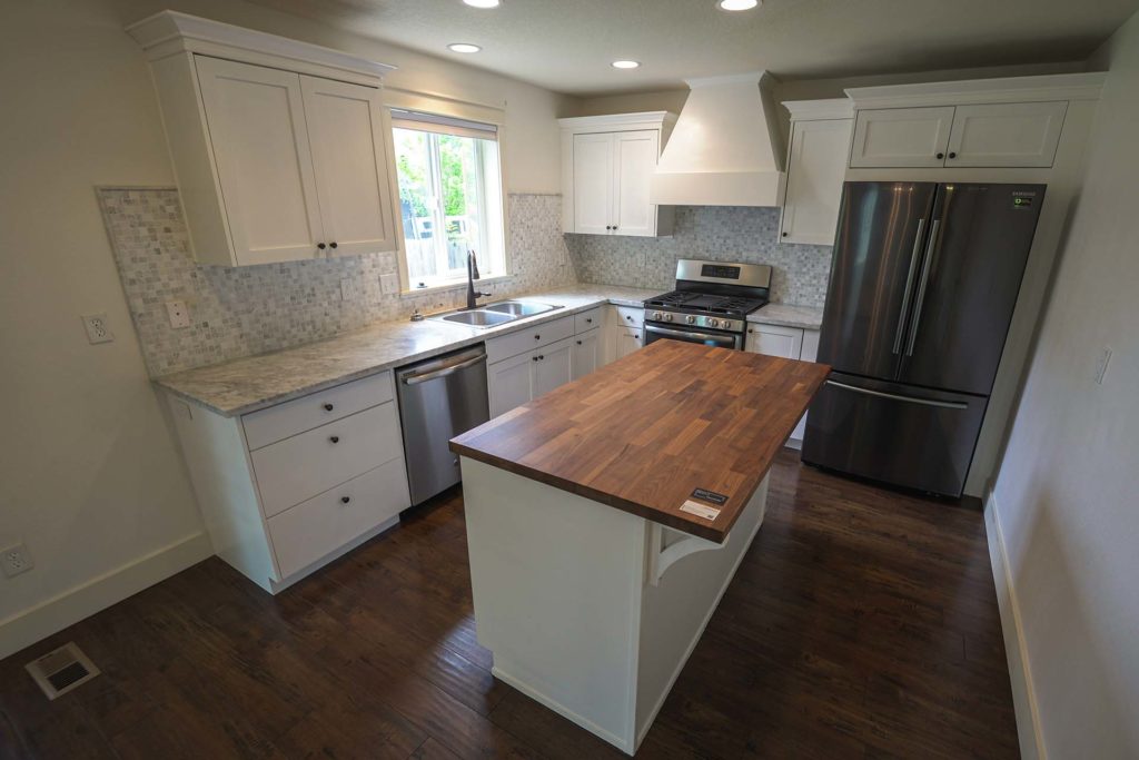 Modern kitchen with butcher-block island and stainless steel appliances