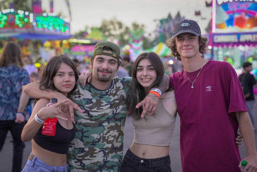 Four friends at the Oregon State Fair, two twenty-something men and two twenty-something women.